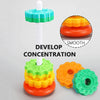 Rainbow spinning stacking tower for toddlers with colorful rings and a white rod designed to develop concentration