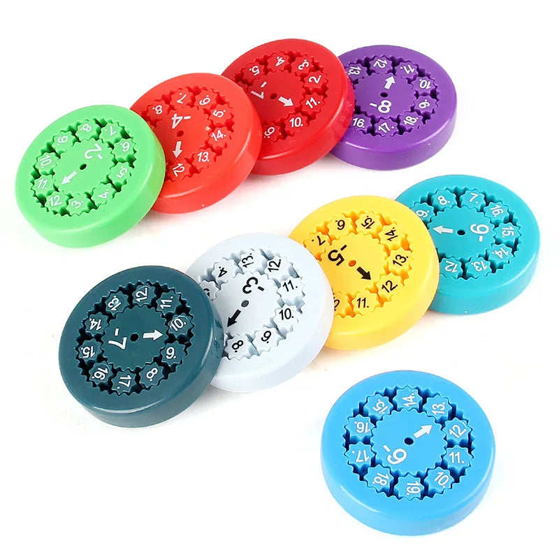 A collection of colorful math fidget spinners used for multiplication practice, featuring various colors like red, green, pur