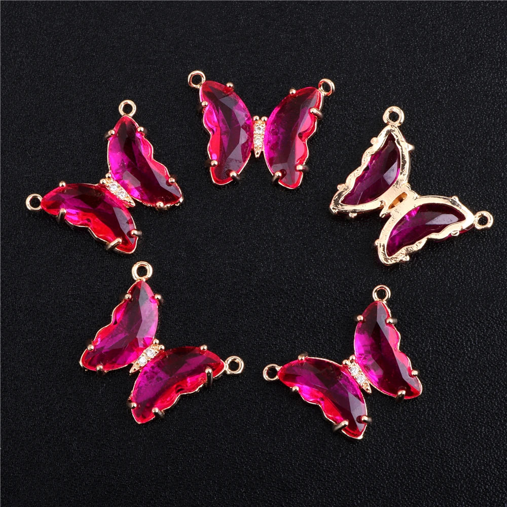 A set of five pink and magenta crystal butterfly charm beads for jewelry making