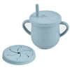 A light blue BPA-free silicone snack cup with a lid and a separate silicone plate for babies and toddlers.