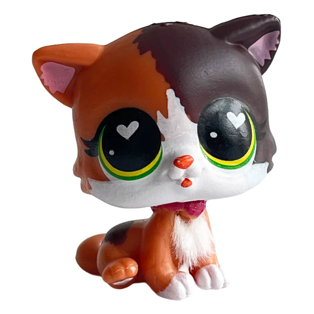 A charming bobble head pet figurine of a cat with orange and brown markings and large eyes.