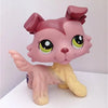 A pink Littlest Pet Shop style standing dog figure with large green eyes and a yellow body.