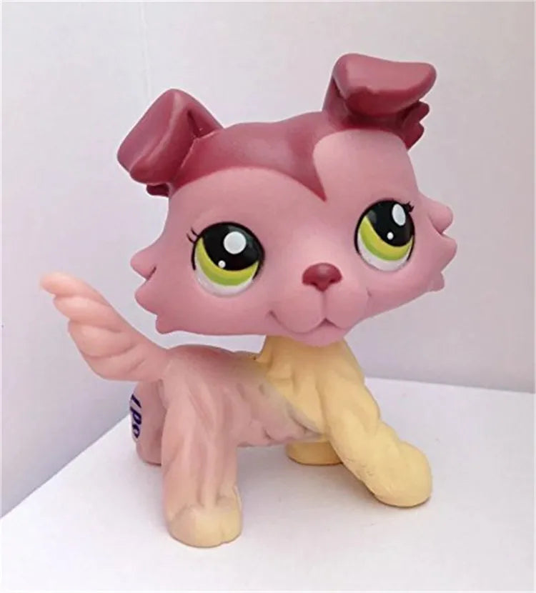 A pink Littlest Pet Shop style standing dog figure with large green eyes and a yellow body.