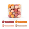 A collection of round, soft silicone beads in various shades of peach, orange, and pink are displayed in a clear container.