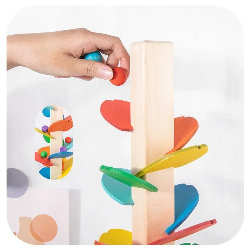 A hand is placing a colored wooden block onto a vertical wooden track toy for learning.