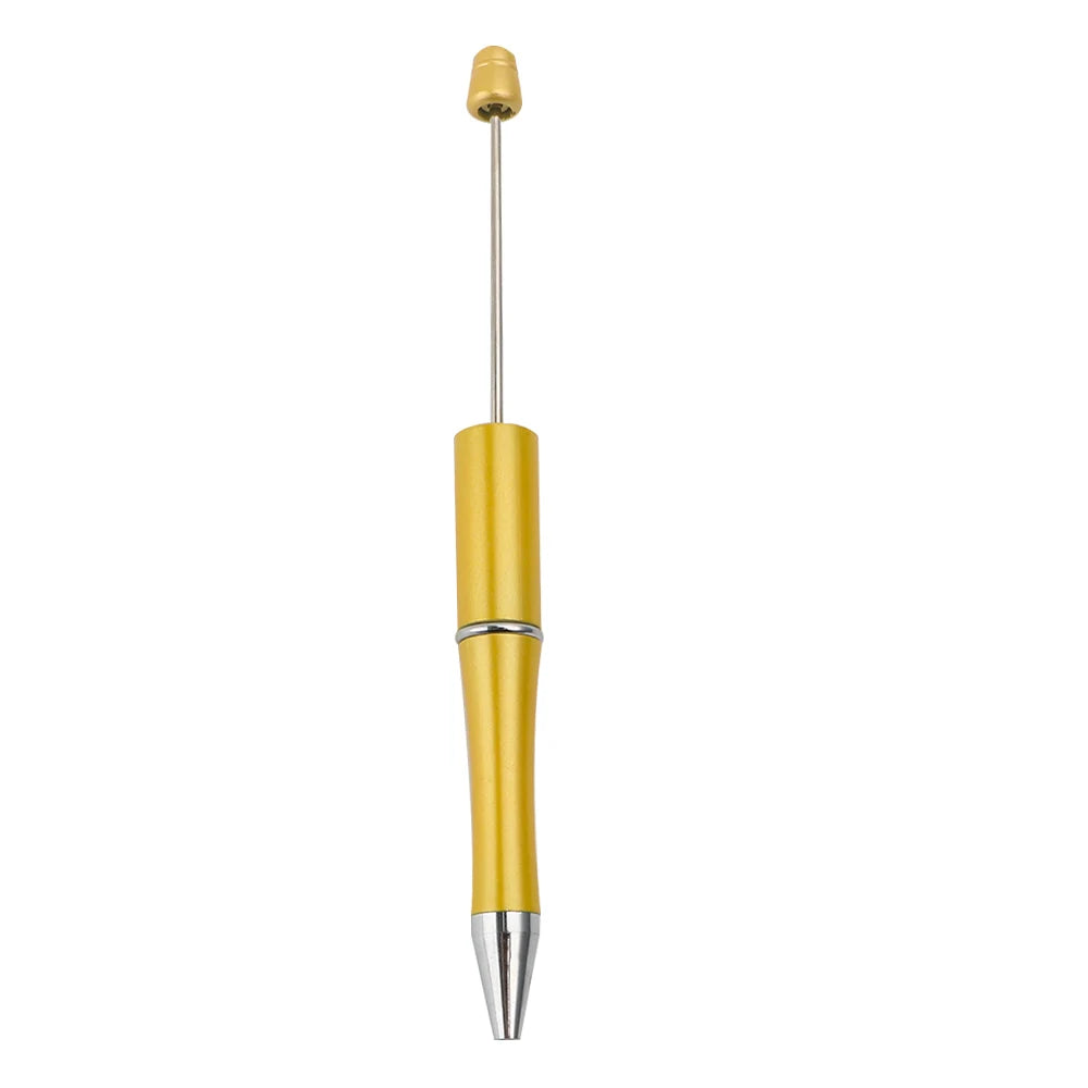 A gold-colored ballpoint pen with a yellow barrel and silver tip.