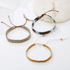 A collection of handcrafted jewelry bracelets and necklaces made with metallic glass beads.