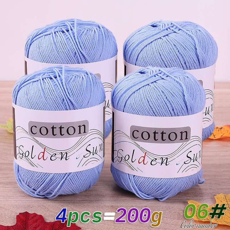 Four skeins of light blue cotton knitting yarn for crochet and handmade projects