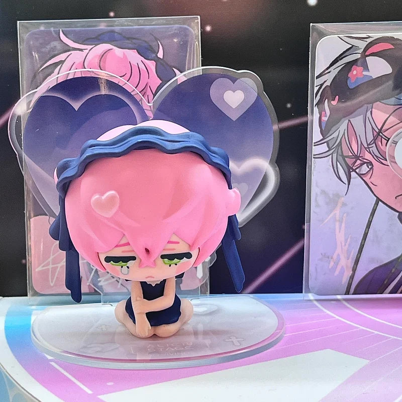 A pink-haired figure with blue accents is displayed in a blind box packaging featuring heart shapes.