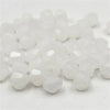 A pile of clear white faceted bicone crystal glass beads for jewelry making.