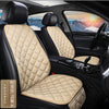 Interior view of a car seat with beige quilted leather cushions and black upholstery.