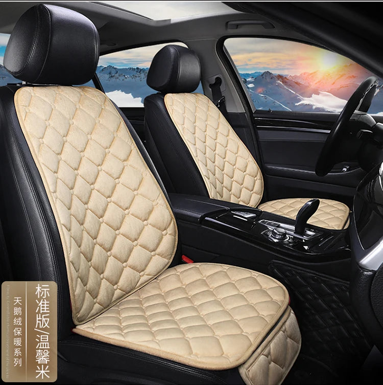 Interior view of a car seat with beige quilted leather cushions and black upholstery.
