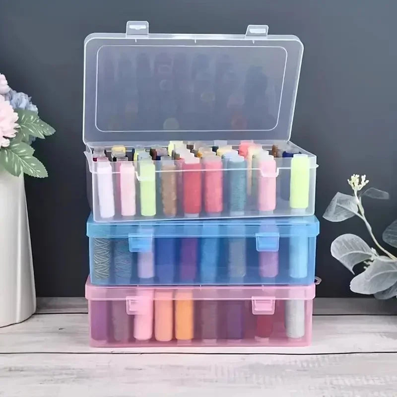 Transparent sewing thread organizer with four compartments holding various colored bobbins.