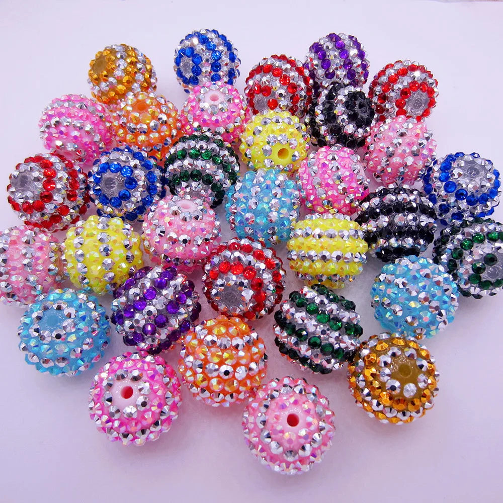 A collection of mixed two-tone striped resin beads in various colors and sizes for jewelry making