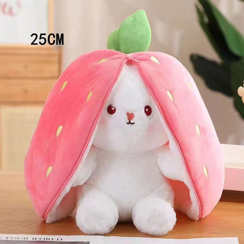 A white bunny plush toy shaped like a pink strawberry with green leaves.