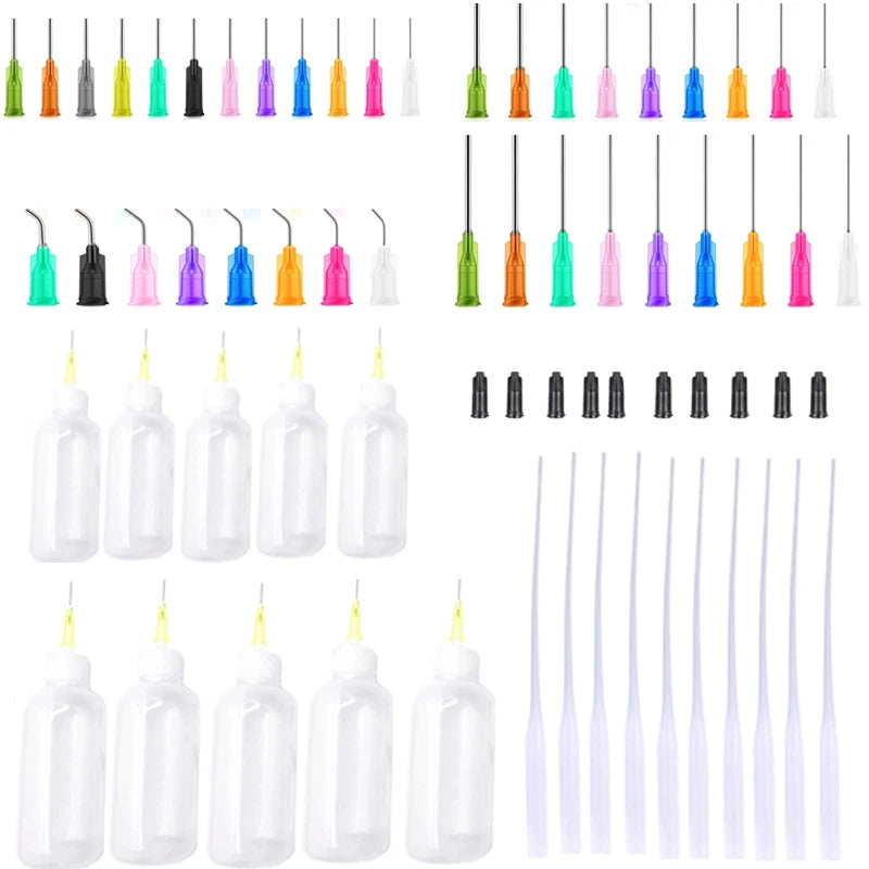 A collection of precision dispensing kit components including various colored needle tips and clear squeeze bottles.