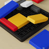 A set of colorful geometric puzzle pieces including red, yellow, blue, and gray shapes arranged on a black grid.