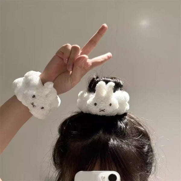 A hand wearing a white Miffy waterproof face wiping wristband is shown against a light background.