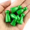 A hand holds a set of twelve wooden game pawns in various shades of green.
