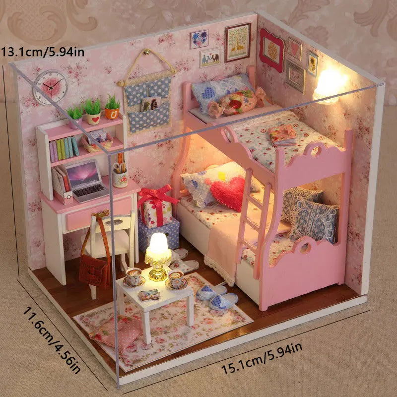 A miniature dollhouse kit featuring a pink wooden bed, furniture, and decorative items displayed within a glass box.
