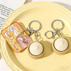 A set of mini steamed bun fidget stress relief toys in light beige and yellow on a pale yellow plate.