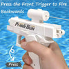 A hand is pressing the front trigger of a white prank gun, which is designed to fire backwards.
