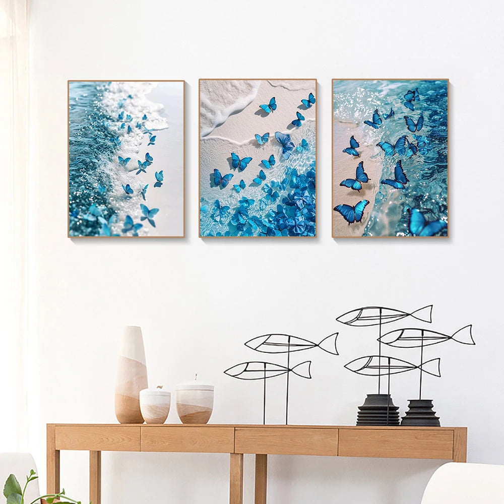 Three framed paintings featuring blue sea waves and butterflies for a diamond painting kit