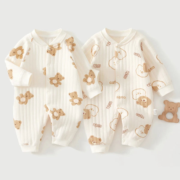 A white cotton jumpsuit for infants featuring a pattern of cute bear and flower designs.