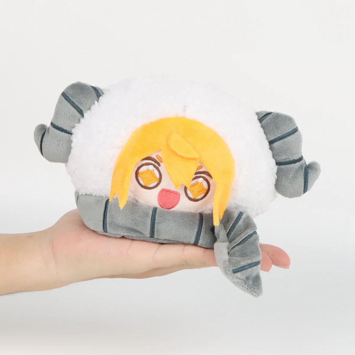 A soft plush doll of Don Quixote with orange hair and white fluffy ears, wearing a gray scarf.