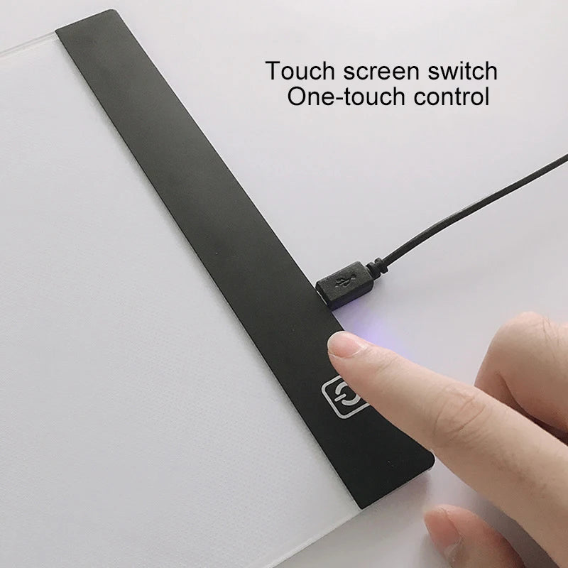 A hand touches a black LED drawing copy pad to activate a touch screen switch for one-touch control.