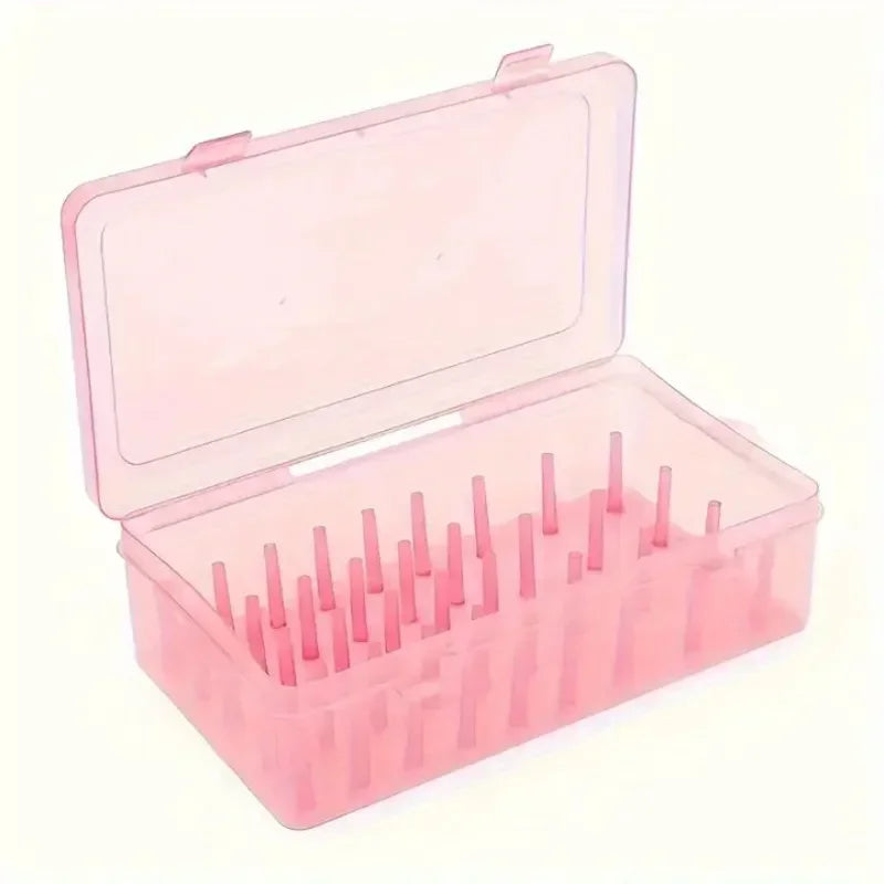 A pink transparent sewing thread organizer with 42 bobbins and 24 compartments.