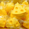 A collection of yellow squishy fidget toys, including a triangular shape, packaged in clear plastic.