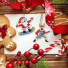 A diamond painting kit featuring a Santa charm pendant and a reindeer charm, set against a rustic wooden background.