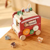 A red wooden animal tourism bus Montessori busy board for toddlers with various animals and features