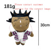 A plush doll resembling Eminem, XXXTentacion, and Frank Ocean with dark hair and a striped outfit.