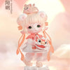 A pink collectible figurine of a girl with cat ears and a fluffy tail, dressed in an orange outfit, standing on a white base.