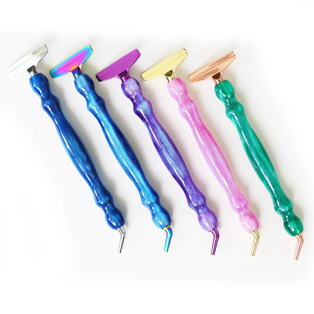 A set of six resin diamond painting pens with various colored and metallic tips arranged diagonally.
