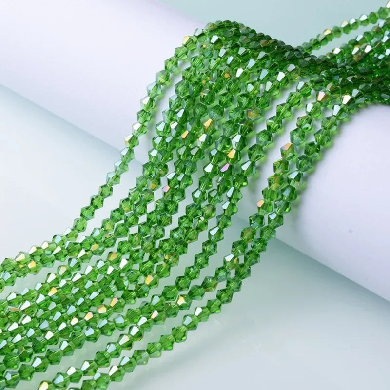 Green faceted glass crystal beads in a twisted strand for jewelry making