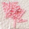 A pile of pink polymer clay marshmallow charms for DIY crafts