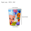 A paper cup featuring a pink cartoon pig character and musical notes, used for party decorations.