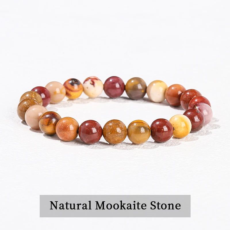 A bracelet made of natural pink quartz stones in various shades of pink, orange, and yellow.