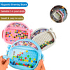 A child's pink and blue magnetic drawing board filled with colorful beads and a pen, shown being held.
