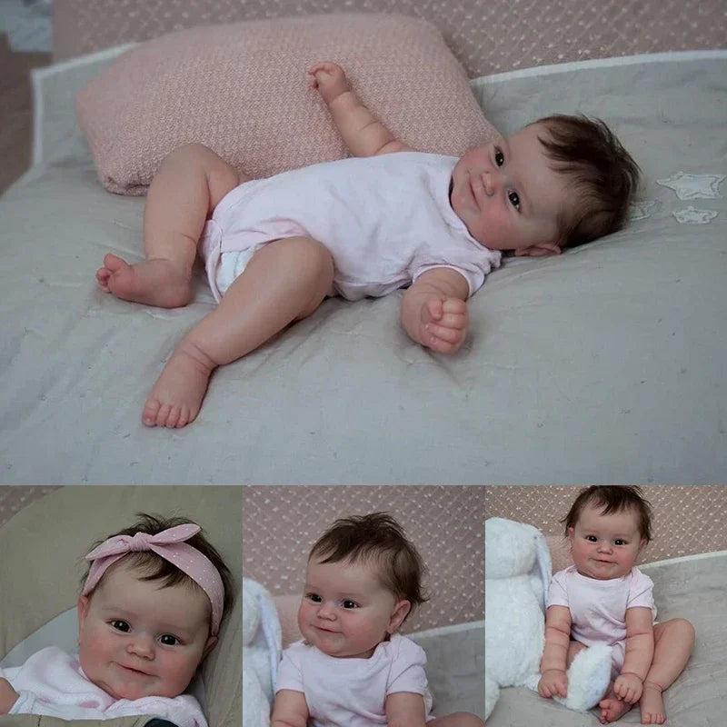 A newborn Reborn baby doll named Maddie with soft body and detailed 3D skin lying on a white surface.