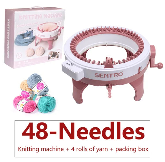 Pink hand-operated knitting machine with 48 needles, yarn rolls, and packaging box.