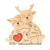 A wooden puzzle decoration featuring three stylized elk figures with names Emma, Olivia, and William.
