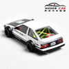 A white diecast model car of the Toyota AE86 in a sporty coupe style.
