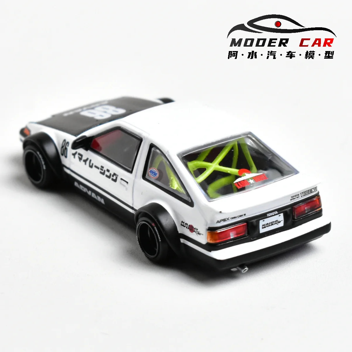 A white diecast model car of the Toyota AE86 in a sporty coupe style.