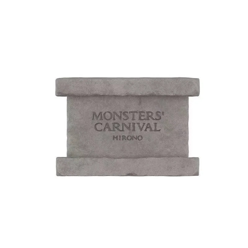 A rectangular gray collectible figure with the text MONSTERS CARNIVAL and MIRONO engraved on the front.