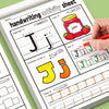 A hand is writing on a page of handwriting activity sheet featuring tracing and writing practice for the letter J.
