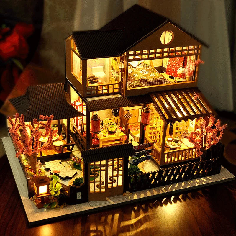A detailed wooden dollhouse with furniture and internal LED lighting, displayed on a dark surface.